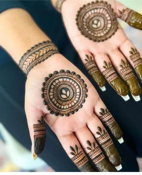 Intricate mandala palm mehndi design with geometric patterns and floral details.