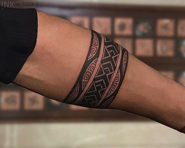 Chevron band mehndi design for men around the wrist.